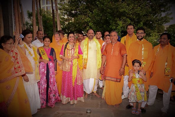 Shri Maa with devotees and volunteers at a Radhesharnam celebration.